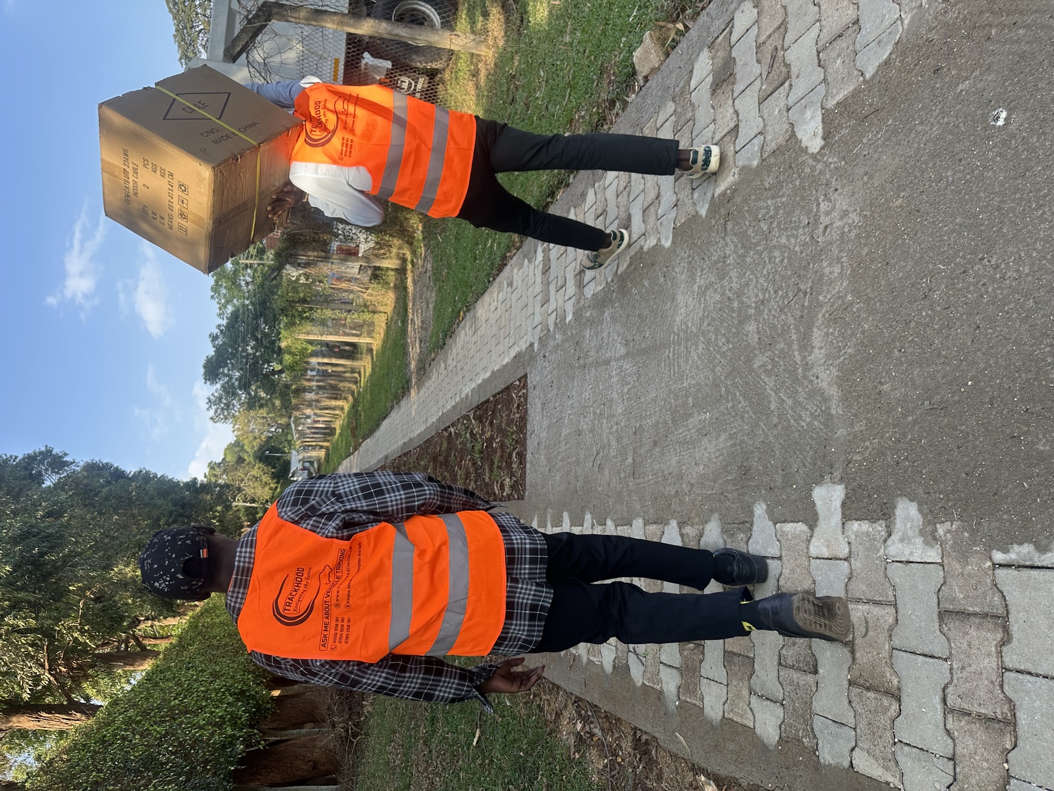Track Hood staff in branded safety vests on delivery